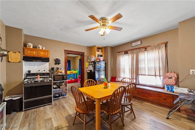 dining room featuring ceiling fan and light wood finished floors