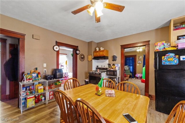 dining space featuring light wood finished floors and ceiling fan