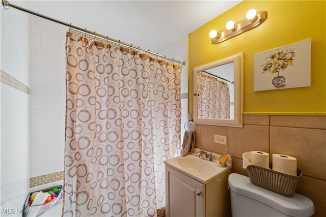 bathroom featuring vanity, tile walls, toilet, and a shower with shower curtain