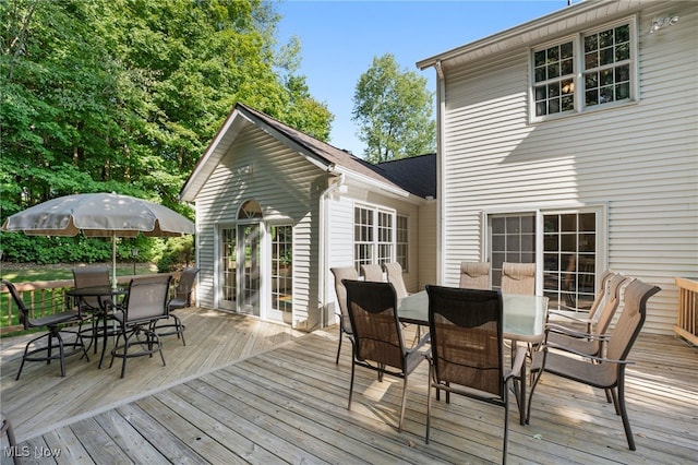 wooden terrace featuring outdoor dining area