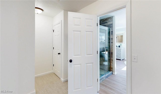 hallway featuring baseboards