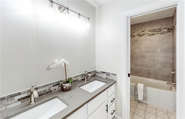 full bathroom with tile patterned floors, tub / shower combination, double vanity, and a sink