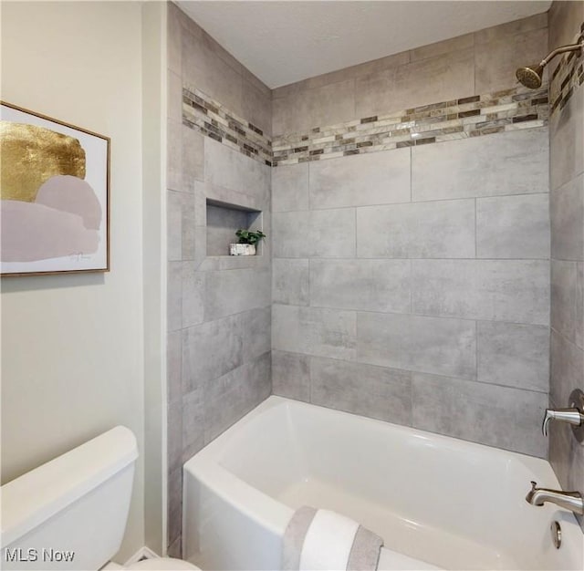 full bath featuring shower / tub combination and toilet