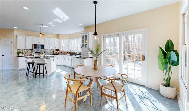 dining space with recessed lighting, baseboards, and light tile patterned floors