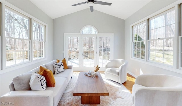 sunroom with lofted ceiling, plenty of natural light, and ceiling fan