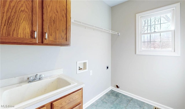 laundry area with a sink, cabinet space, baseboards, hookup for an electric dryer, and hookup for a washing machine