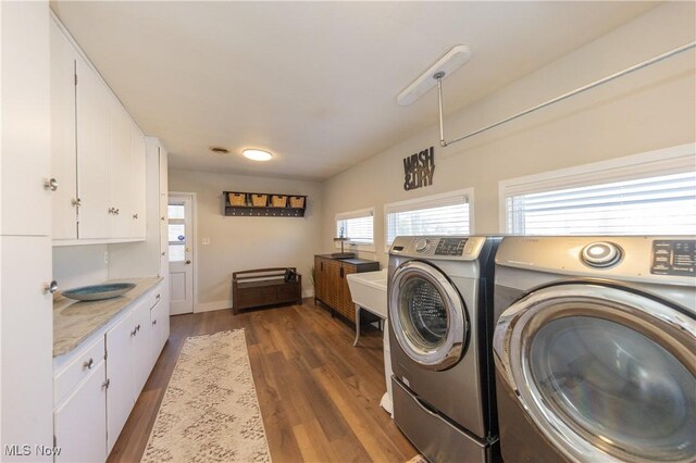 laundry area featuring washing machine and clothes dryer and wood finished floors