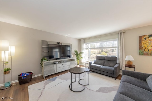 living room with wood finished floors and baseboards