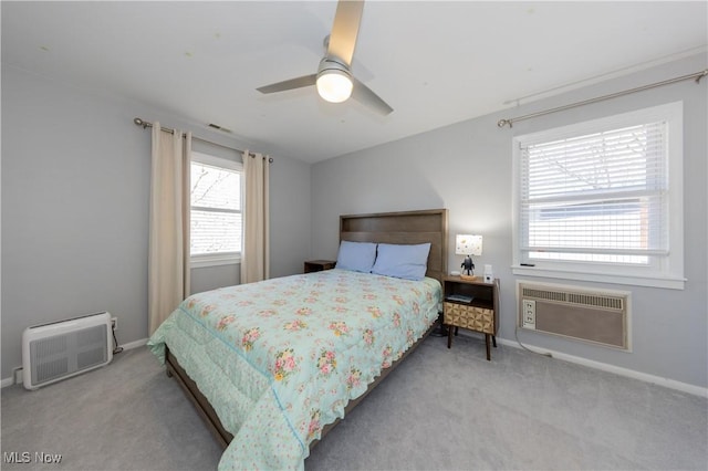 bedroom featuring visible vents, baseboards, carpet flooring, and a wall mounted AC