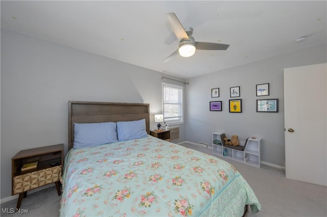 carpeted bedroom featuring baseboards and ceiling fan