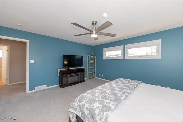 carpeted bedroom with visible vents, ceiling fan, and baseboards