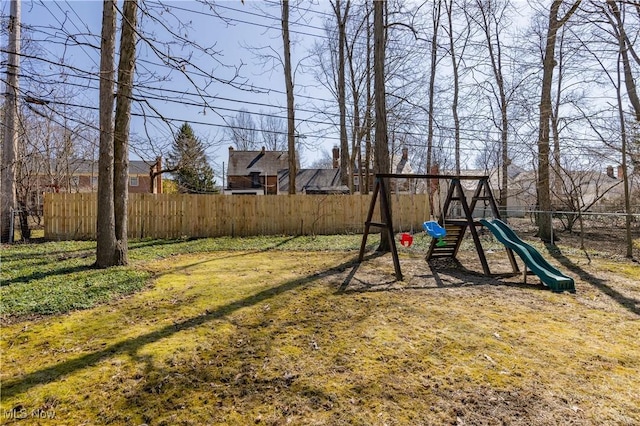 view of yard featuring a playground and fence