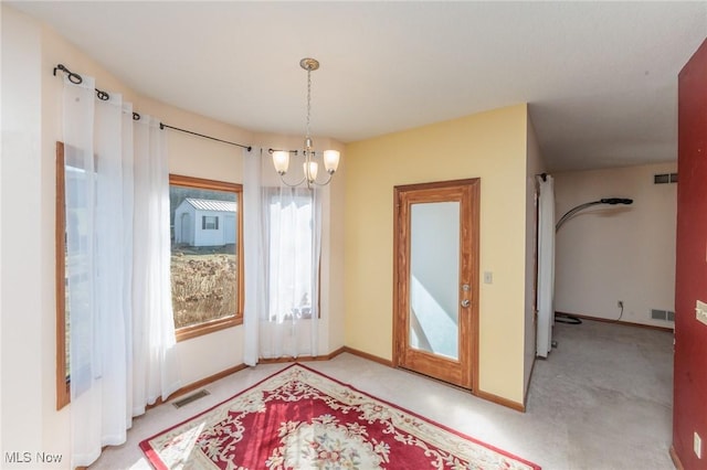 interior space featuring a chandelier, visible vents, and baseboards