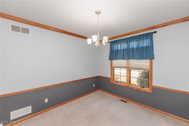 carpeted spare room featuring a notable chandelier, visible vents, and ornamental molding