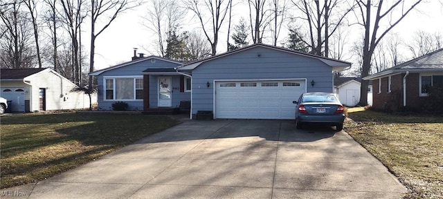 ranch-style home with driveway, an attached garage, and a front yard