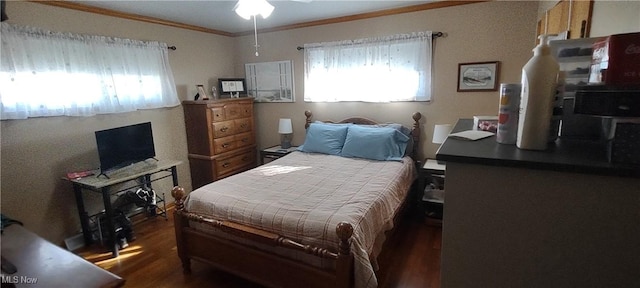 bedroom featuring wood finished floors and ornamental molding