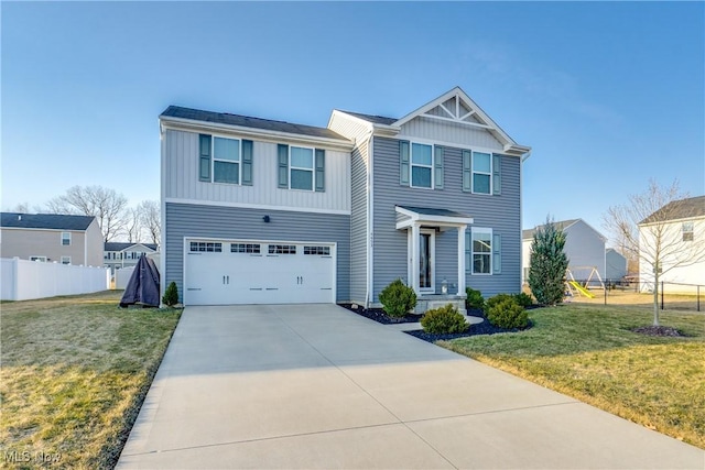 view of front of home with driveway, an attached garage, a front yard, and fence