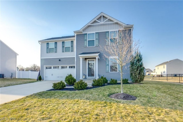 view of front facade featuring a front yard, fence, a garage, and driveway