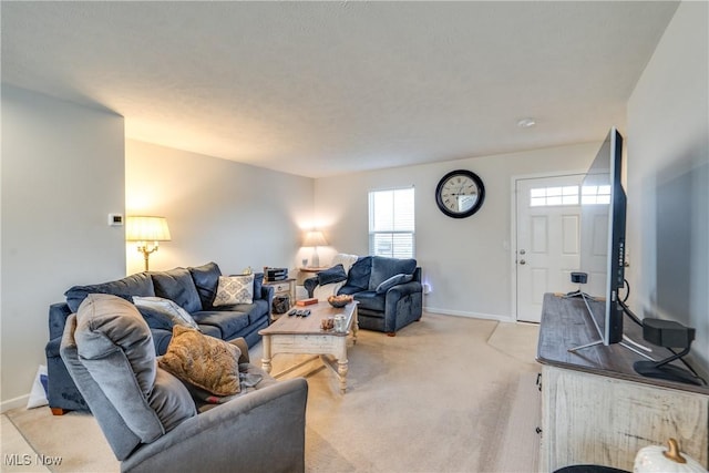 living area featuring baseboards and light colored carpet