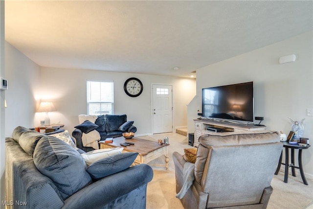 living area with baseboards and light colored carpet