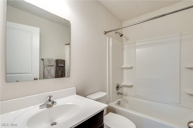 bathroom featuring toilet, vanity, and shower / bath combination