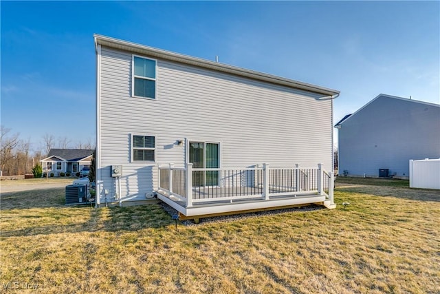 back of house with a yard, central AC unit, and a wooden deck