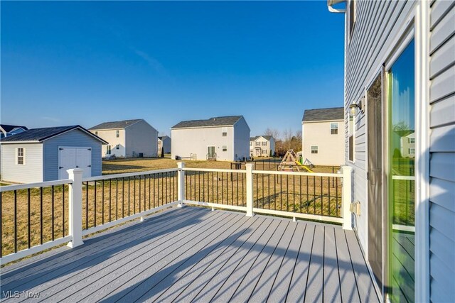 deck with a residential view and an outdoor structure