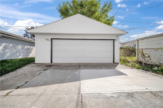 detached garage featuring fence