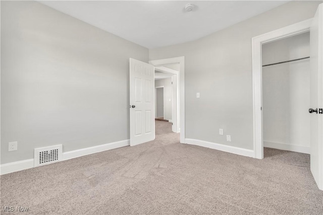 unfurnished bedroom featuring visible vents, baseboards, and carpet