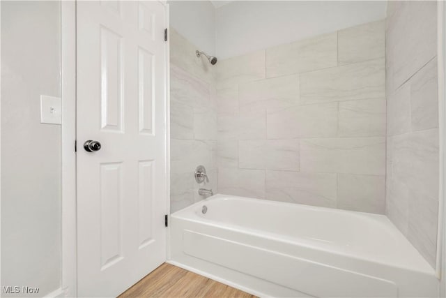 bathroom featuring tub / shower combination and wood finished floors