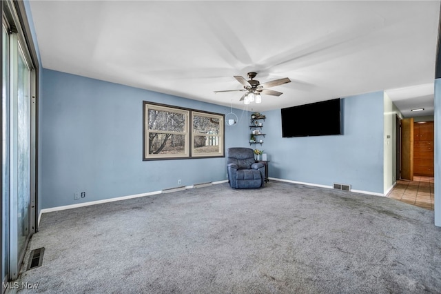 unfurnished room featuring visible vents, carpet floors, baseboards, and ceiling fan