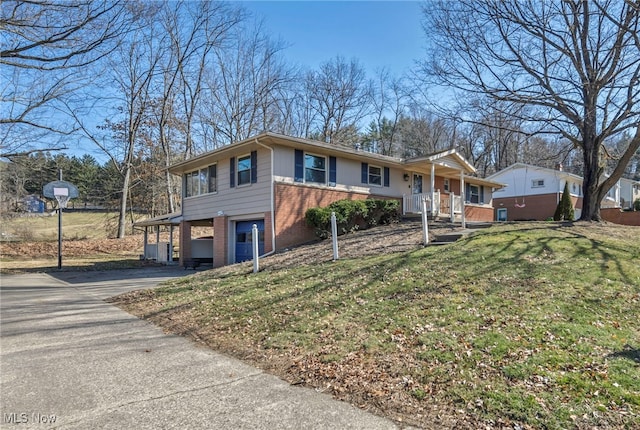 ranch-style house with a garage, a front yard, brick siding, and driveway