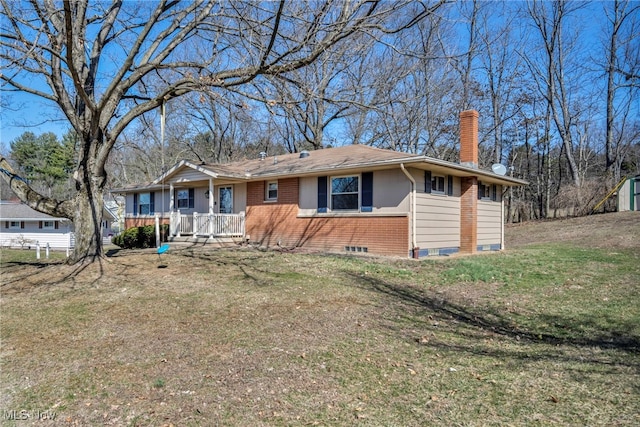 view of front of house with a front lawn, covered porch, and a chimney