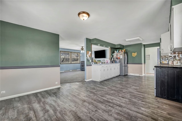 kitchen with ceiling fan, dark wood finished floors, open floor plan, freestanding refrigerator, and white cabinetry