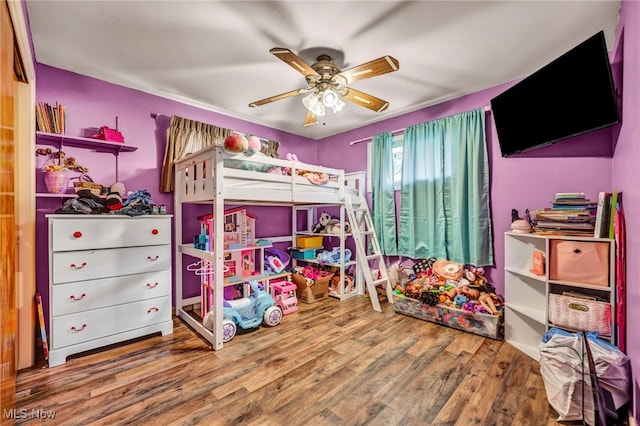 bedroom featuring wood finished floors and a ceiling fan