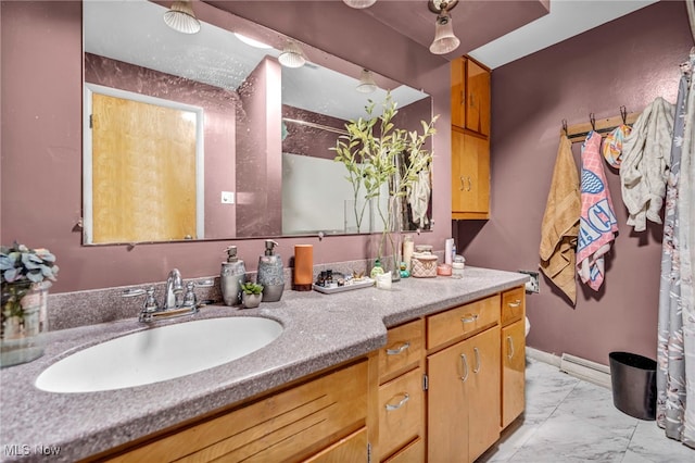 bathroom with vanity, baseboards, and marble finish floor