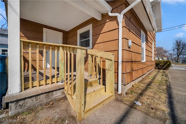 view of exterior entry with a deck