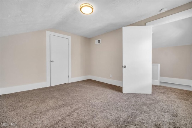 bonus room featuring visible vents, lofted ceiling, baseboards, and carpet flooring