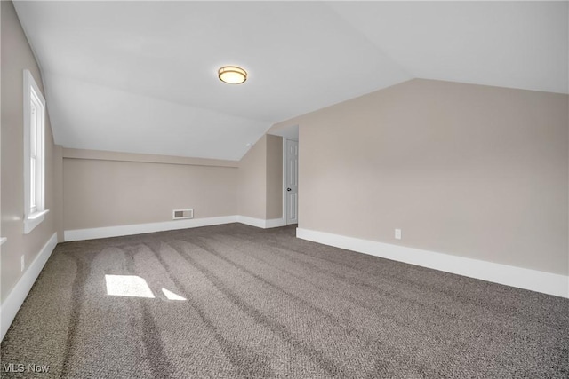 bonus room with visible vents, baseboards, carpet flooring, and vaulted ceiling