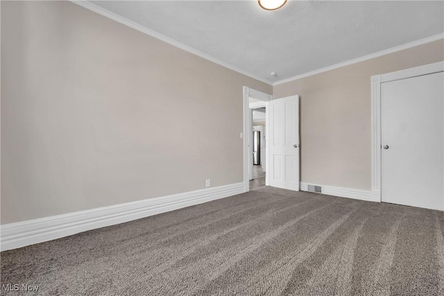 unfurnished room with carpet flooring, baseboards, visible vents, and ornamental molding