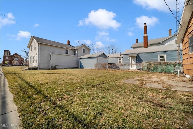 view of yard featuring a garage and fence