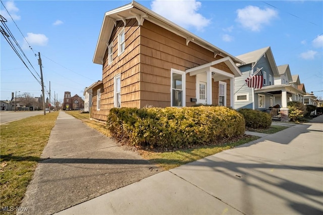 view of property exterior with a residential view