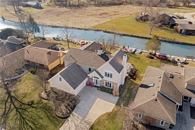 drone / aerial view featuring a residential view and a water view