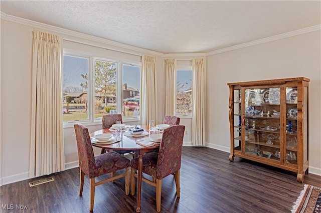 dining space featuring visible vents, baseboards, a textured ceiling, and dark wood-style flooring