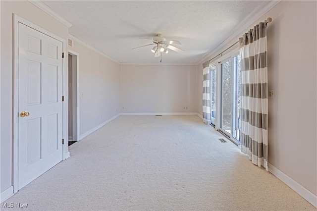 unfurnished room featuring light carpet, a textured ceiling, crown molding, and ceiling fan