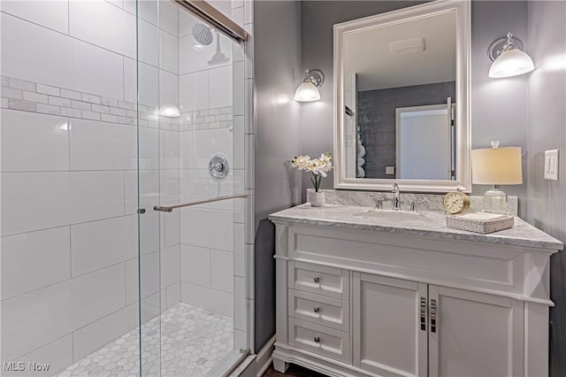 full bathroom with a stall shower and vanity