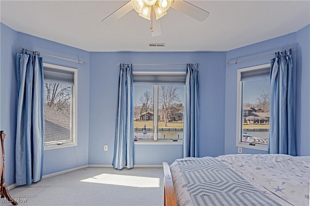 bedroom featuring baseboards, visible vents, carpet floors, and ceiling fan