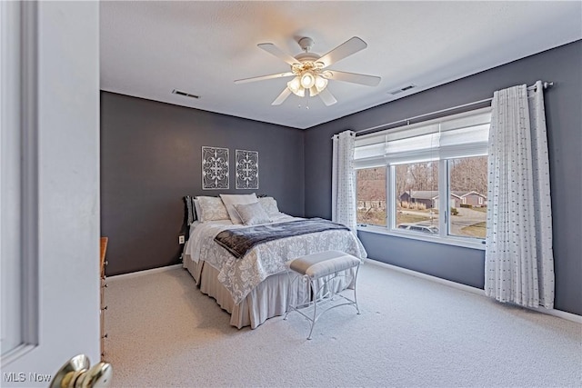 bedroom with visible vents, carpet, and ceiling fan