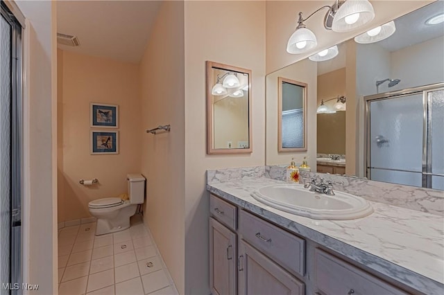 full bath featuring tile patterned floors, toilet, a stall shower, baseboards, and vanity