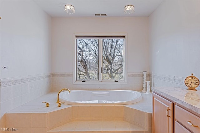 full bathroom with a bath and visible vents